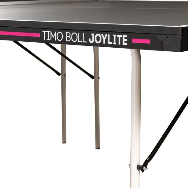 Butterfly Timo Boll Joylite Indoor Ping Pong Table showing us the 16mm top along with the 36mm side rails with the pink stripe and the table name running down the side rail.